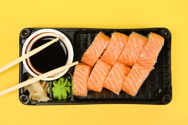 Top view of sushi set isolated on yellow background