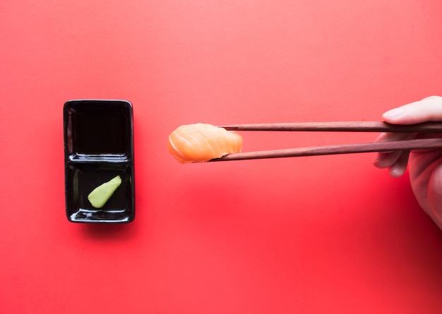 Photo top view, sushi with chopsticks.