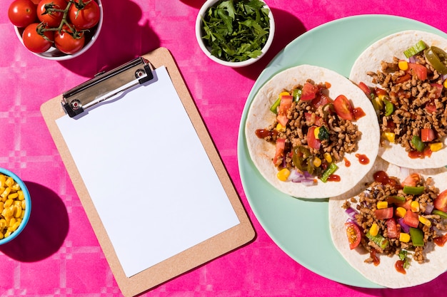 Photo top view tacos and clipboard arrangement