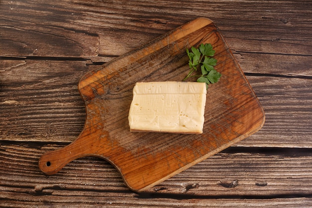 Top view of tasty cheese on a cutting board