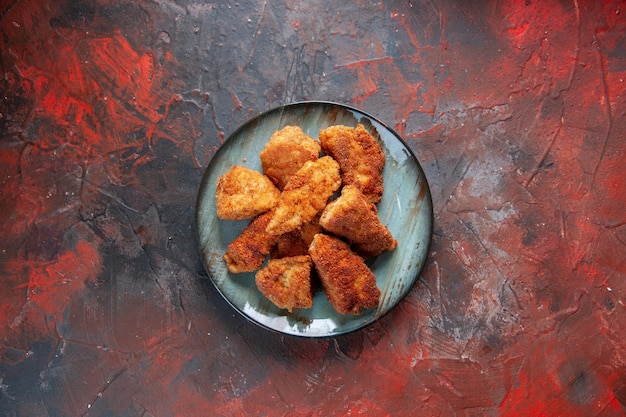 Top view tasty chicken wings inside plate on dark surface dinner burger food fries meat sandwich meal