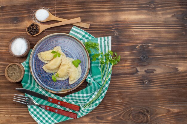 top view tasty cooked hotcakes with seasonings on brown wooden desk cooking meal pie oven cake bake biscuit cuisine dough free space