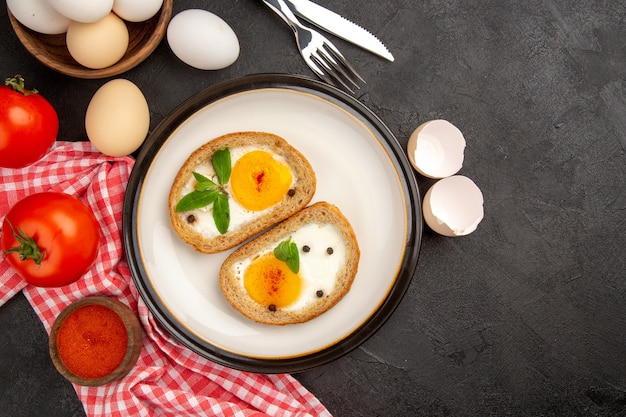 top view tasty egg toasts with red tomatoes on dark background meal bread omelette food lunch breakfast tea