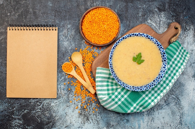 top view tasty lentils soup inside plate with raw orange lentils on gray background cuisine photo meal pepper colors dinner vegetable dish