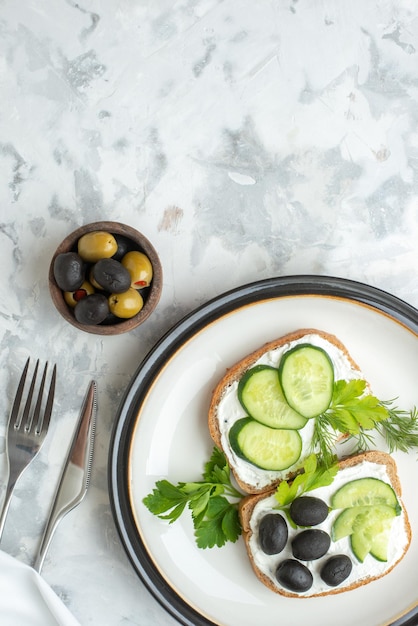 Top view tasty sandwiches with cucumbers and olives inside plate white background toast meal burger food bread lunch horizontal