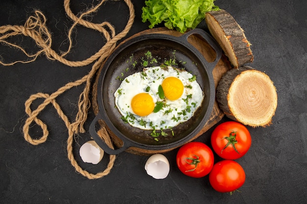 top view tasty scrambled eggs with greens and tomatoes on dark background omelette tea breakfast bread meal morning lunch food