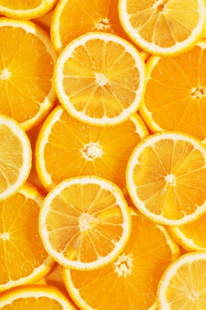 Top view of tasty slices of orange and lemon. Bright summer background. Healthy food. Proper nutrition. Fresh juices. Copy space, flat lay. Backdrop texture of fruits. Citrus products concept.