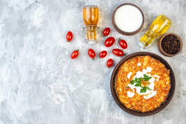 Top view tasty tomato omelette with fresh tomatoes and greens on white background morning breakfast scrambled eggs bread milk lunch free space