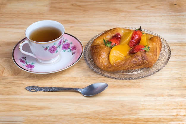 Top view of the teacup and dessert served 