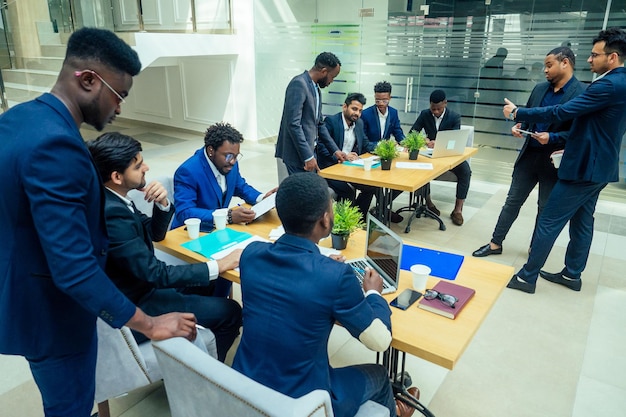 Top view of team work high five a group of successful afro americans europeans arabic and korean businessman and businesswoman working