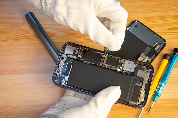 Top view of a technician repairing a smartphone