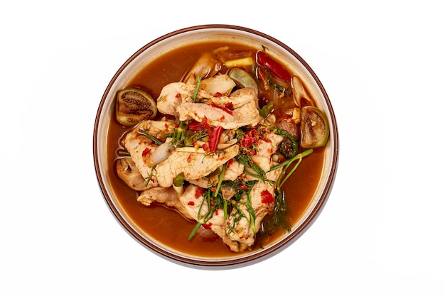 Top view of Thai Pork curry with Dill isolated on white background That is local food of Isan in Thailand This menu contains many vegetables such as dill brinjal chilli lemongrass and red onions