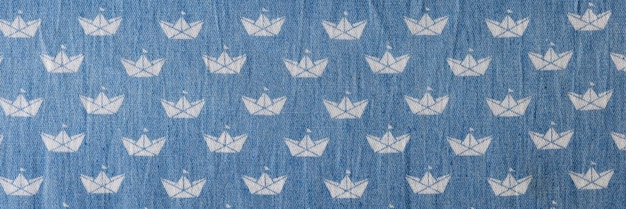 Top view of thin blue jeans fabric with white geometric print pattern of smooth stylish cloth