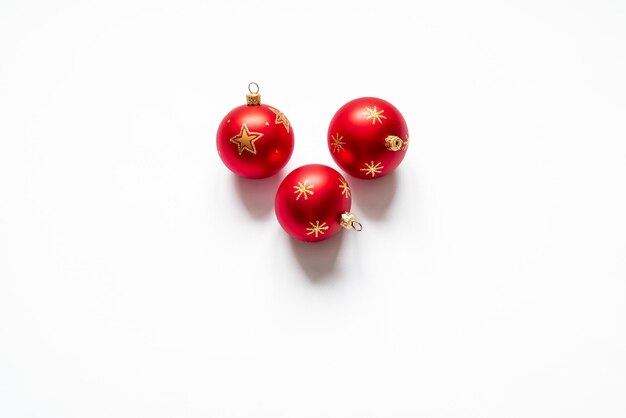 Top view of three red christmas balls on white background