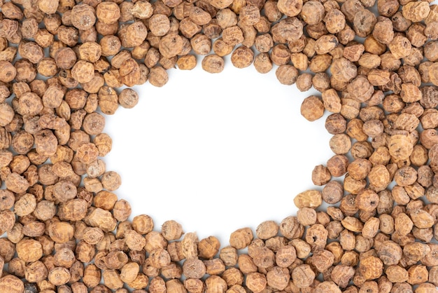 Top view of a of tigernuts on a white background with copy space in the middle