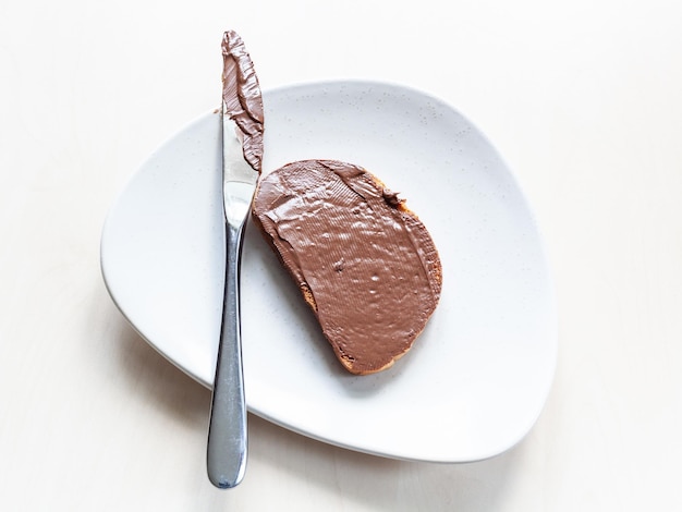 Top view of toast with chocolatte spread and knife