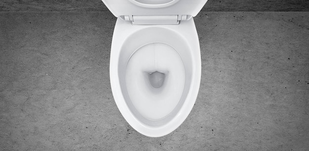 Top view of toilet bowl in the bathroom on cement background