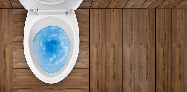 Top view of toilet bowl blue detergent flushing in it