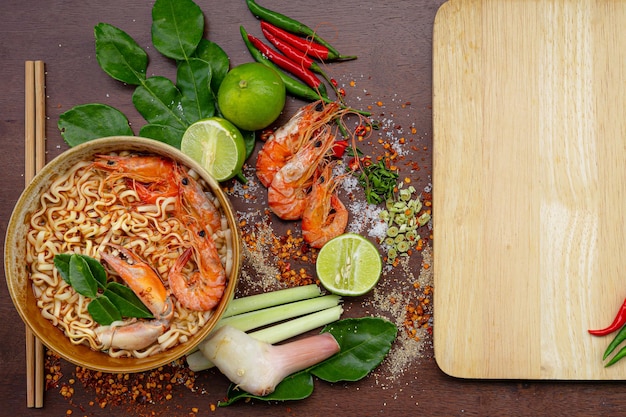 Top view Tom Yum Kung on wooden background Its local in Thai food Prawn soup is popular and fam