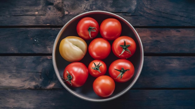 Top view of tomatoes in bowl and on wooden surface