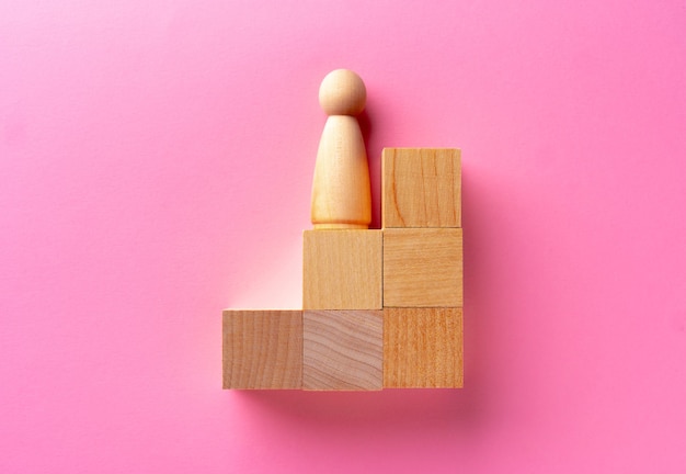 Top view of toy wooden blocks on pink