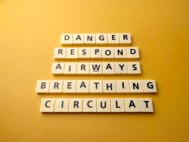 Top view toys letters with the word danger respond airways breathing circulat