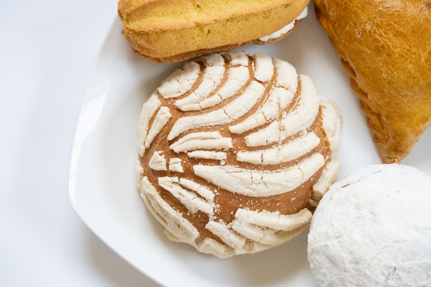 Top view of traditional mexican assorted breads on white background with copy space