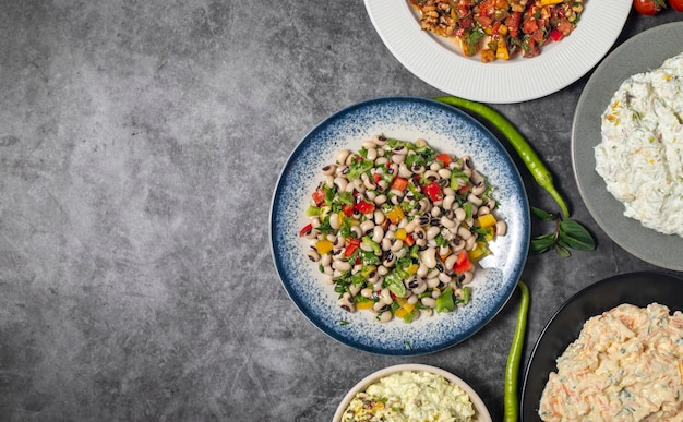 Top view traditional Turkish and Greek dinner appetizer table Mediterranean appetizer concept Copy space Cretan pate dry cowpea salad roasted eggplant salad carrot tarator gavurdagi salad