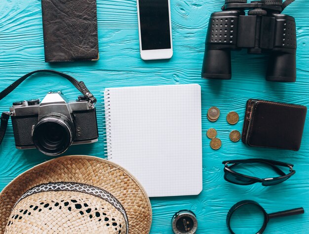 Top view of travel accessories set on wooden blue  background with copy space