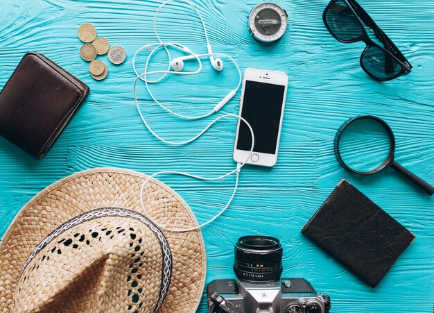 Top view of travel accessories set on wooden blue  background with copy space