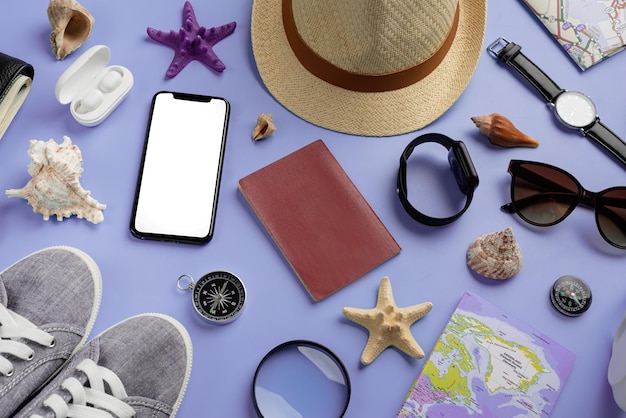 Top view travel accessories with shoes map smartphone with mockup screen hat on very peri purple background