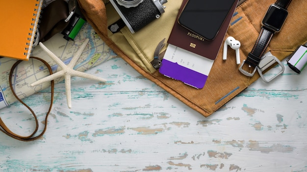 Top view of Travel items with smartphone, camera, boarding pass and other travel accessories