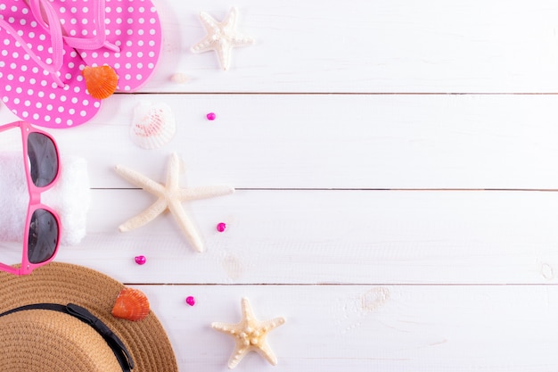 Top view of traveler accessories and airplane on white wooden background. Summer or vacation concept