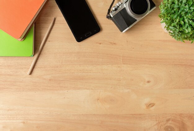 Top view of traveler accessories on brown wooden background with copy space , Travel conce