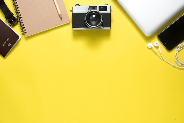 Top view of Traveler's accessories on yellow background