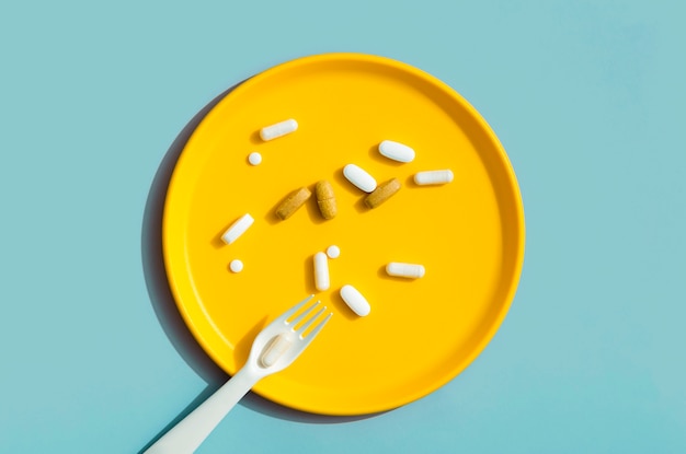 Top view of tray with pills and fork