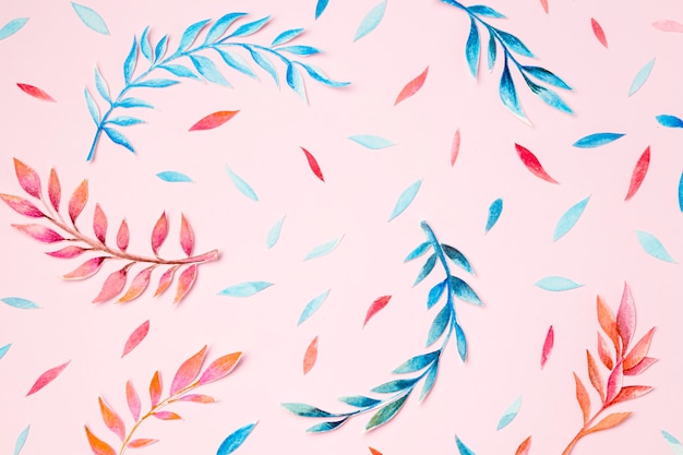 Top view tropical leaves on pink background