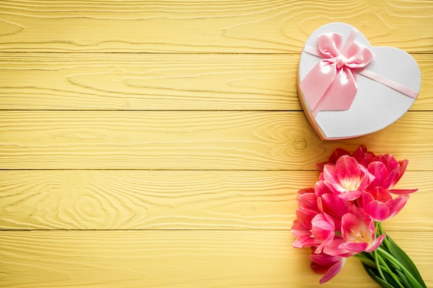 Top view of tulips on wood table. Woman's day. 8 March. Spring holiday concept