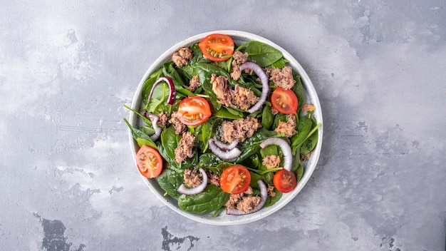 Top view of tuna salad with tomatoes and onion. Top view