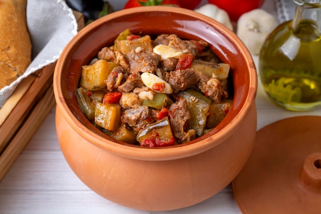 Top view of Turkish dish Guvech baked meat with eggplant and traditionally served in earthenware pot Turkish name etli patlican guvec or patlican tava