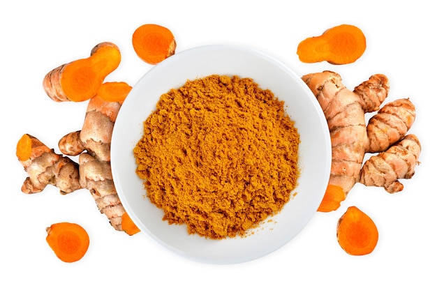 Top view of Turmeric roots with turmeric powder isolated on white