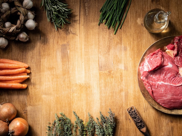 Top view of two juicy chunks of red meat next to carrots. Copy space available.