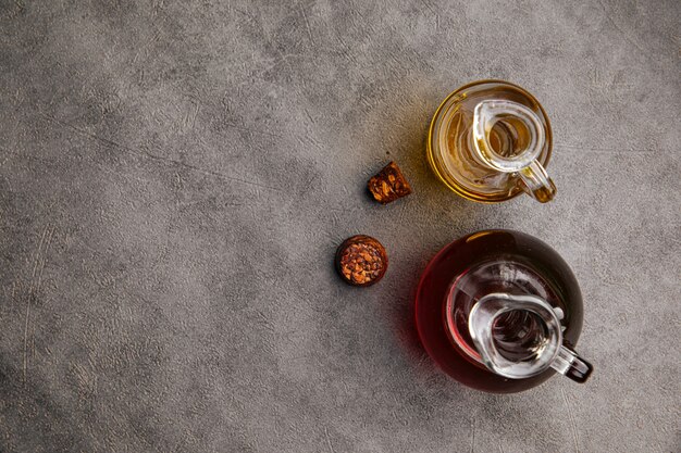 Top view on two lass jugs with oil for cooking