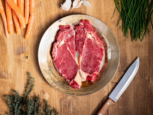 Top view of two pieces of red meat on a vintage plate. Food preparation. Natural protein. Healthy meal.