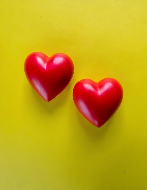 Top view two red heart shape on yellow background with copy space can use for heart check