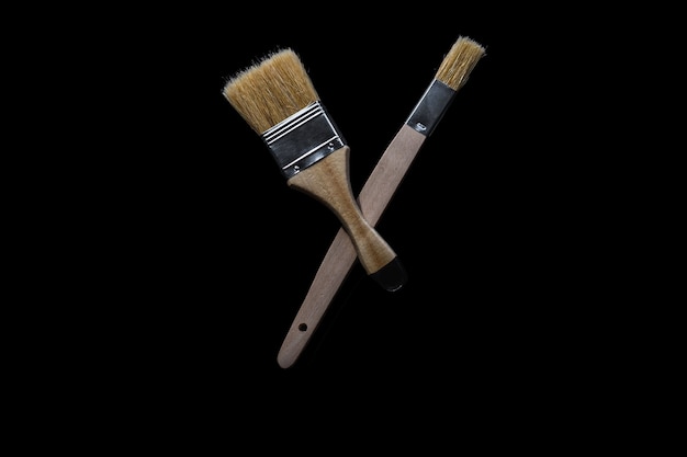 Top view of two whitewashing brush on black background