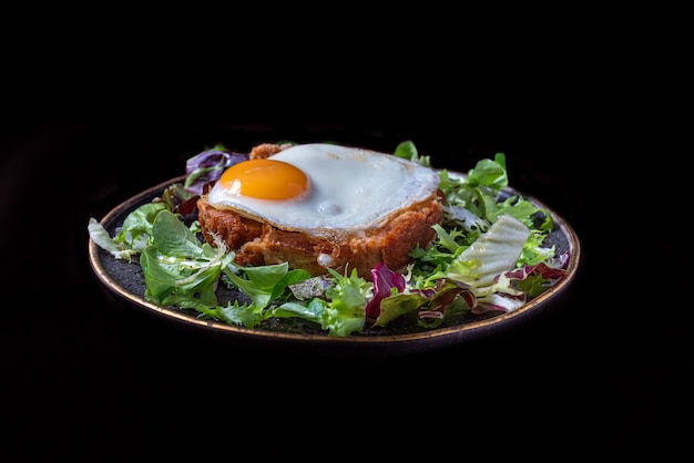 Top view of a typical portuguese dish,  Alheira (in portuguese) with egg and salad - mediterranean food