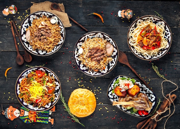 Top view on uzbek oriental cuisine dishes on the wooden surface