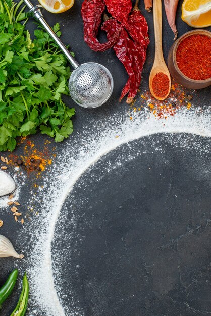 Top view of various fresh foods set with flour around