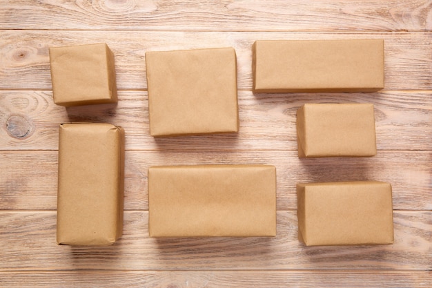 Top view of various gift boxes on wooden table, blank